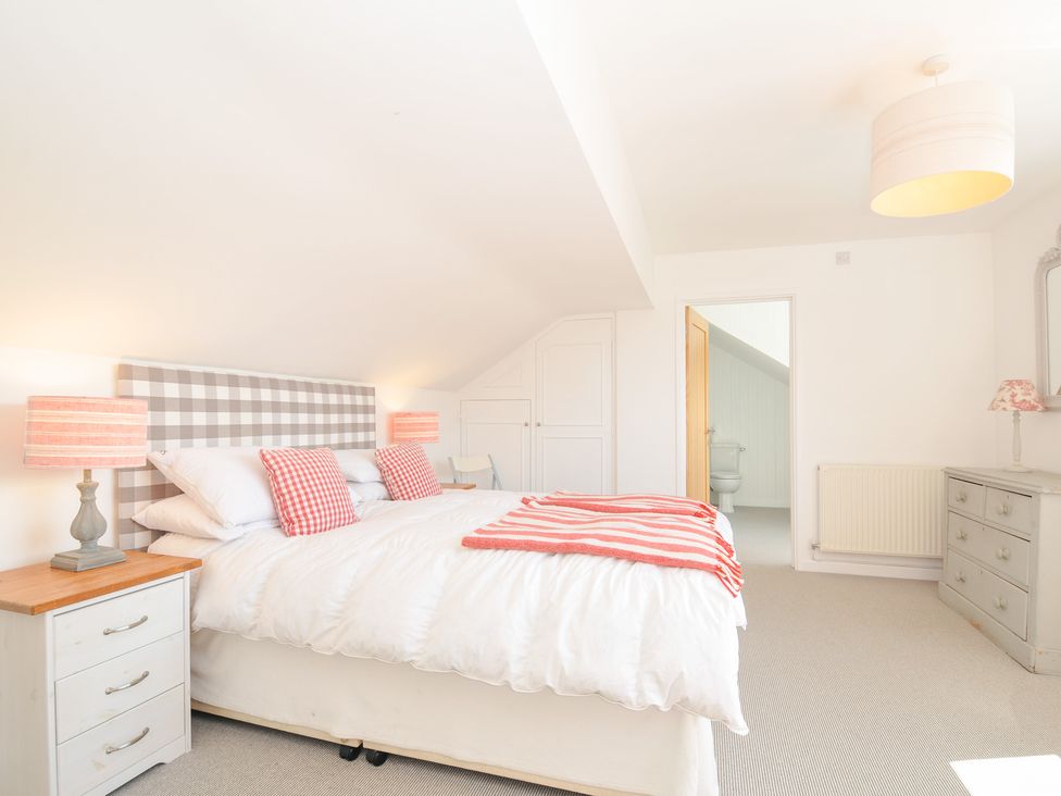 A bedroom with a bed and lamps at Porthilly Brook in Rock