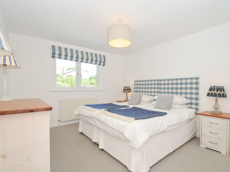 A bedroom with a bed and lamps at Porthilly Brook in Rock
