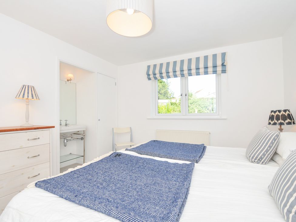 A bedroom with twin beds and a dresser at Porthilly Brook in Rock