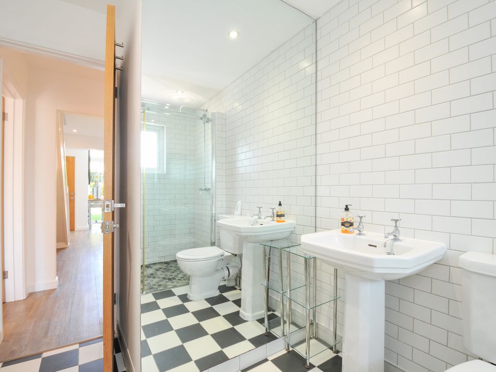 A bathroom with sinks and a shower at Porthilly Brook Rock