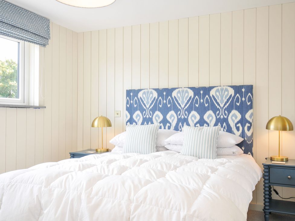 A bedroom with a bed and lamp at Porthilly Brook in Rock
