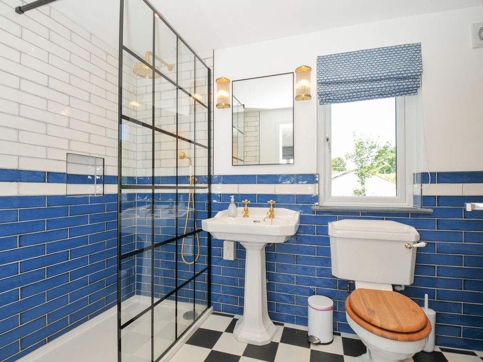 A bathroom with a shower, sink, and toilet at Porthilly Brook in Rock