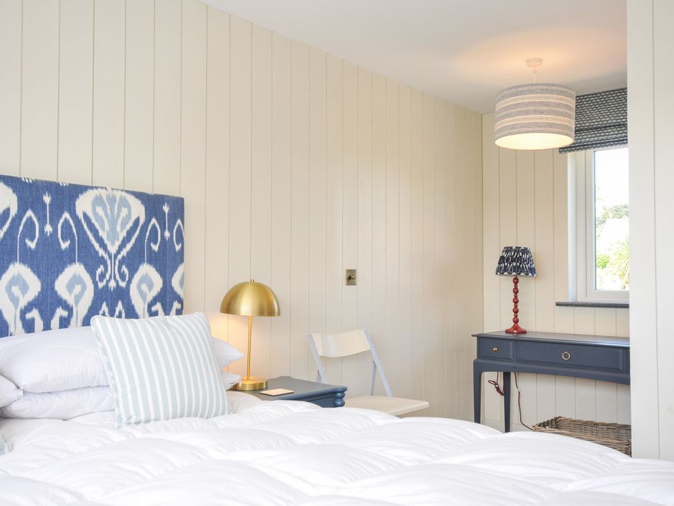 A bedroom with a bed and desk at Porthilly Brook in Rock