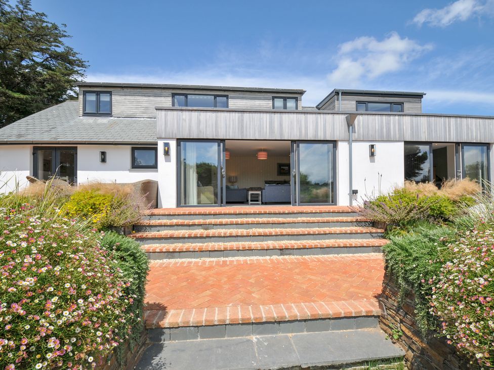 A house with large windows and steps at Porthilly Brook in Rock