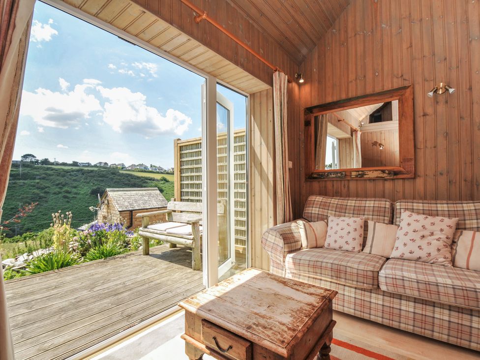A living room with a sofa and coffee table at Cartway Cabin Port Isaac