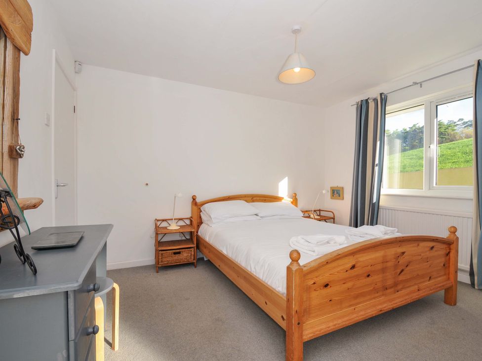 A bedroom with a bed and nightstand at Upper Gren in Trebetherick