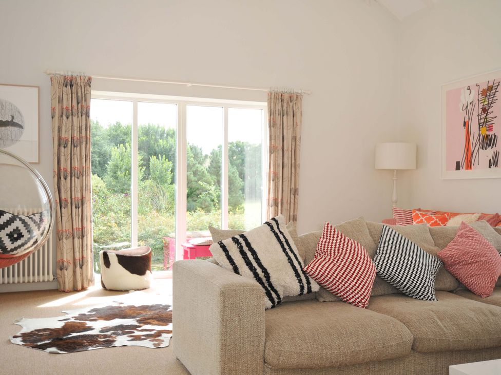A living room with a sofa and cushions at The Old Granary in Rock