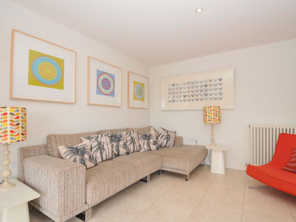 A living room with a sofa and artwork at The Old Granary in Rock