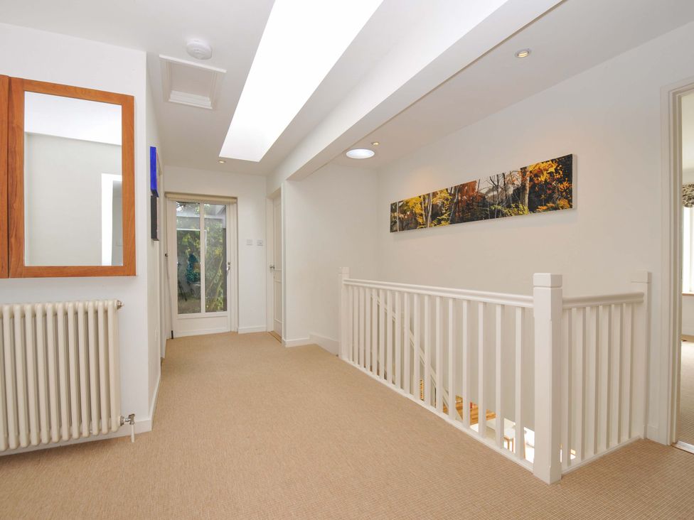 A hallway with a mirror and radiator at The Old Granary in Rock