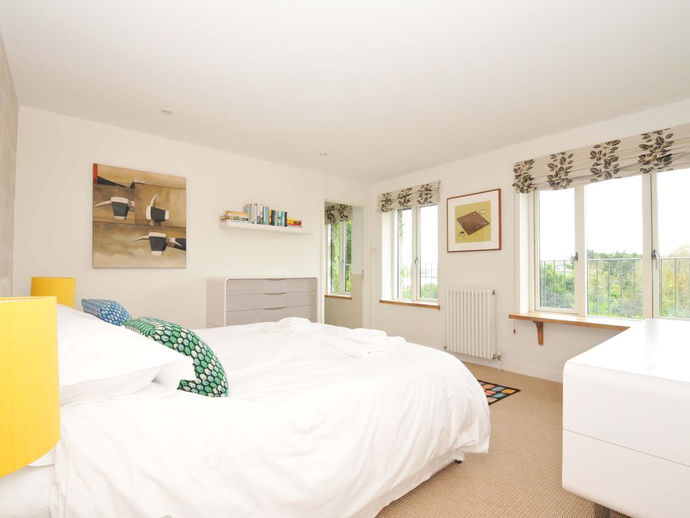A bedroom with a bed and bookshelf at The Old Granary in Rock