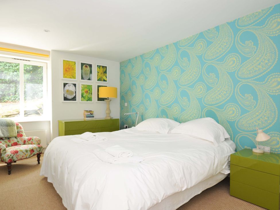 A bedroom with a bed and wall art at The Old Granary in Rock