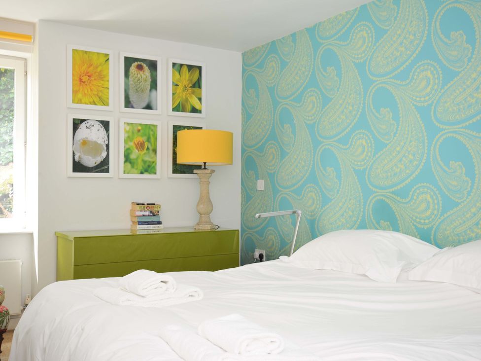 A bedroom with a bed and pictures on the wall at The Old Granary in Rock