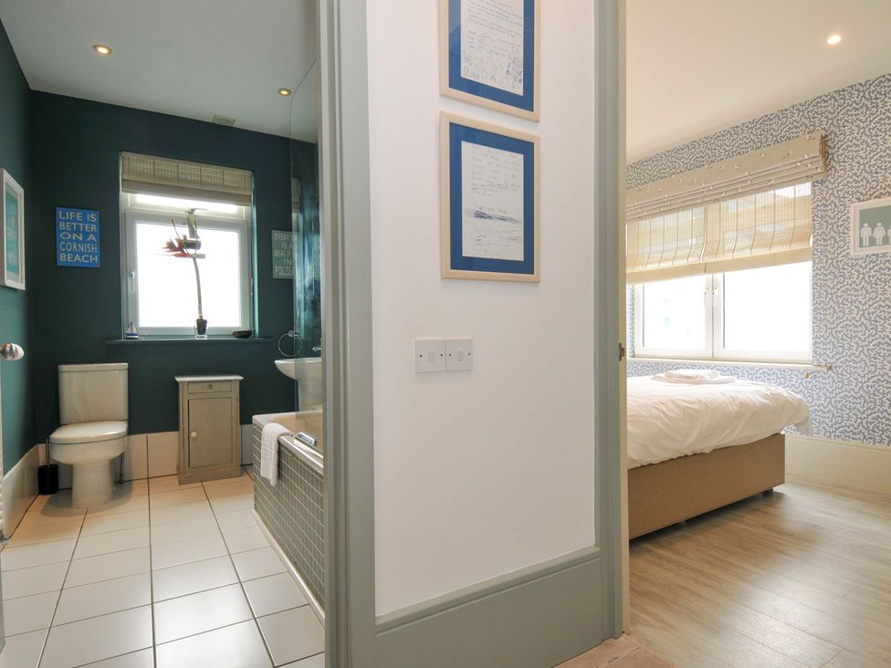 A bathroom with a bathtub and toilet at The Point in Polzeath