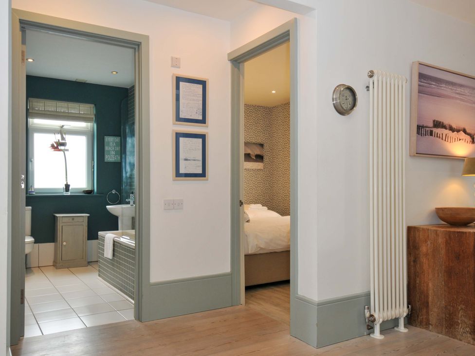 A hallway leading to a bathroom and bedroom at The Point in Polzeath