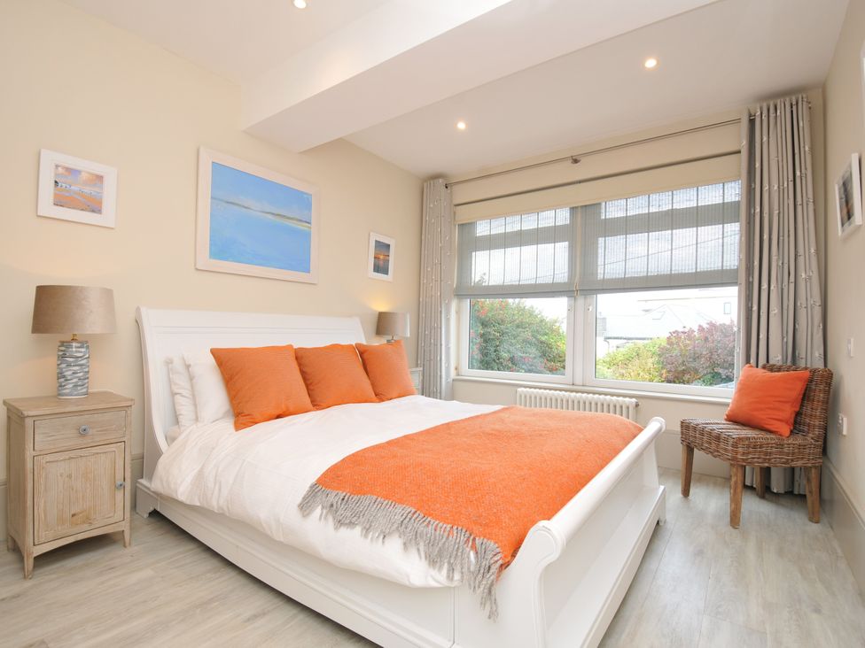 A bedroom with a bed and a bedside table at The Point in Polzeath