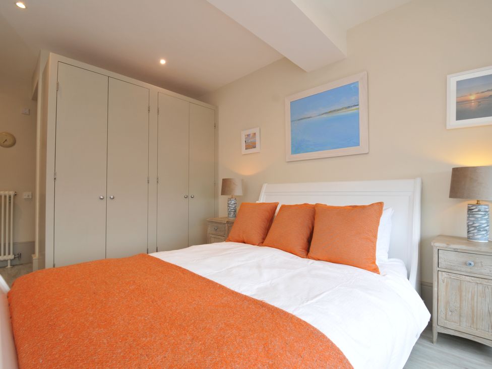 A bedroom with a bed and wardrobe at The Point in Polzeath