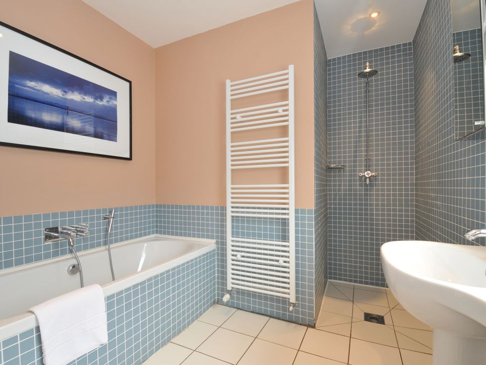 A bathroom with a bathtub, toilet, and shower at The Point in Polzeath