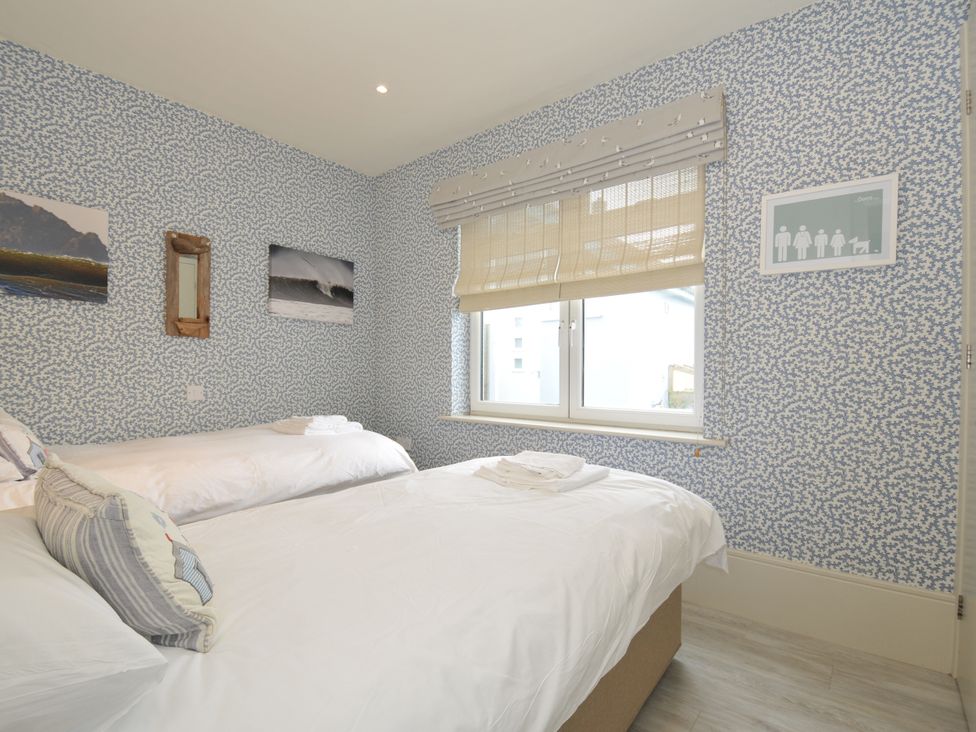 A bedroom with two beds and a window at The Point in Polzeath