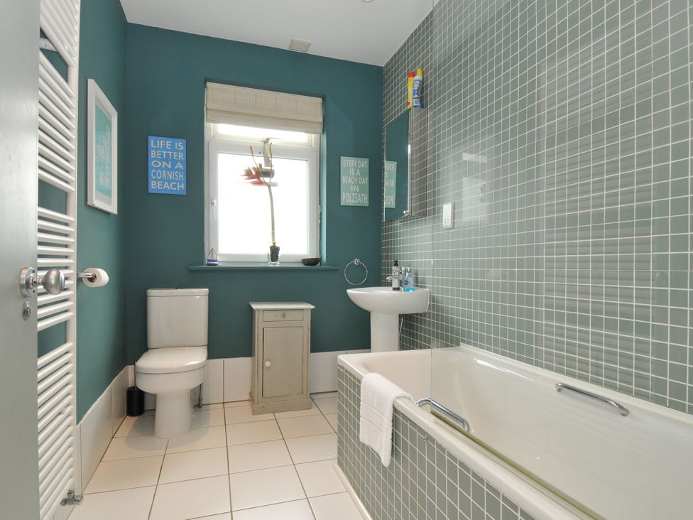 A bathroom with a sink, toilet, and bathtub at The Point in Polzeath