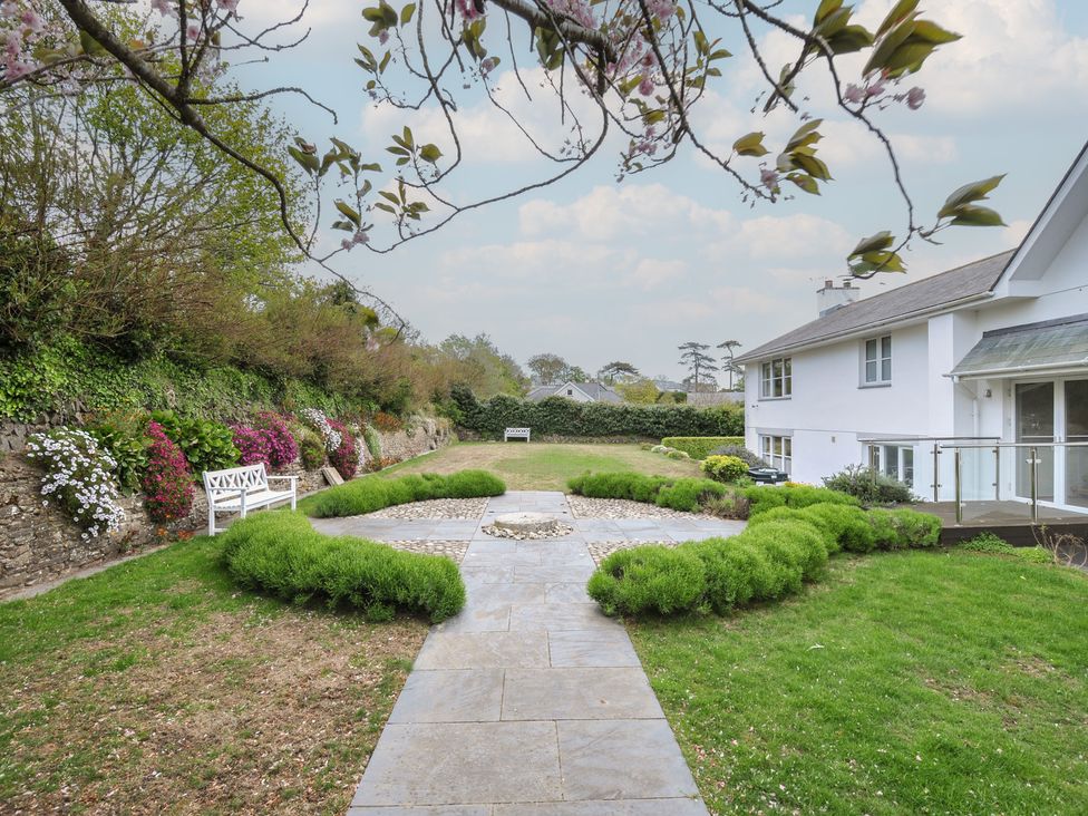 A garden with flowers, a bench, and a pathway at Cherrytrees in Rock