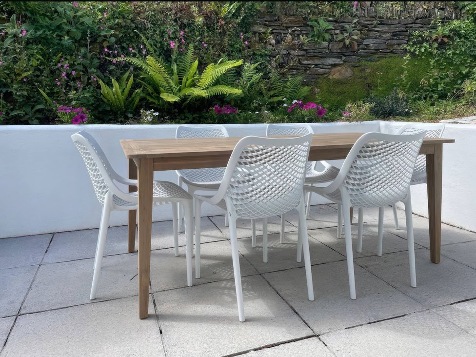 An outdoor dining table with chairs at Beaches, Polzeath