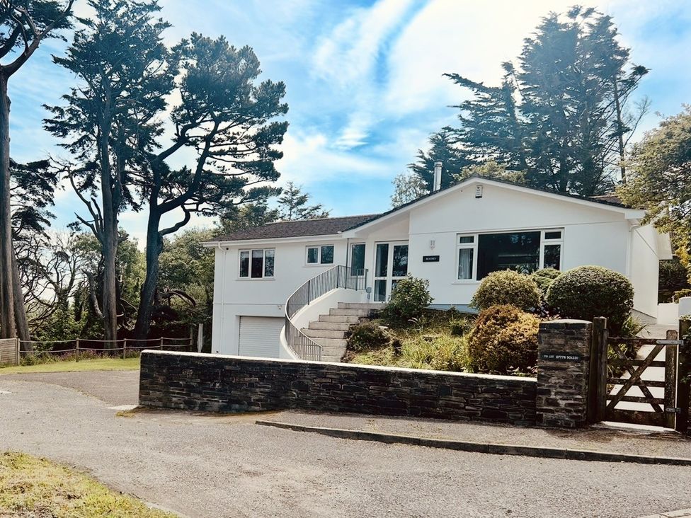 A house with a garage and steps at Beaches in Polzeath