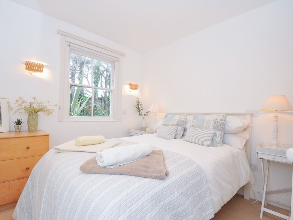 A bedroom with a bed and windows at Sandy Lodge Rock