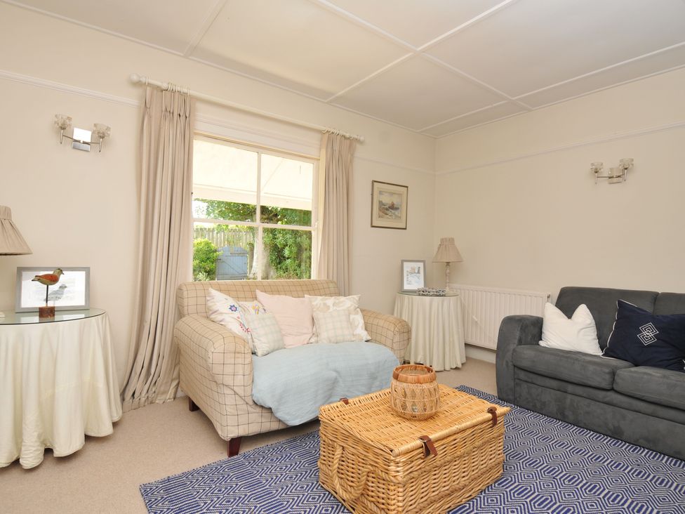 A living room with a sofa, armchair and coffee table at Sandy Lodge Rock