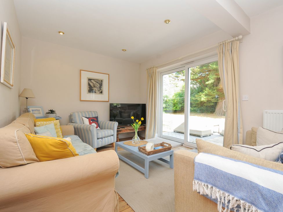 A living room with a television and coffee table at Sandy Lodge Rock