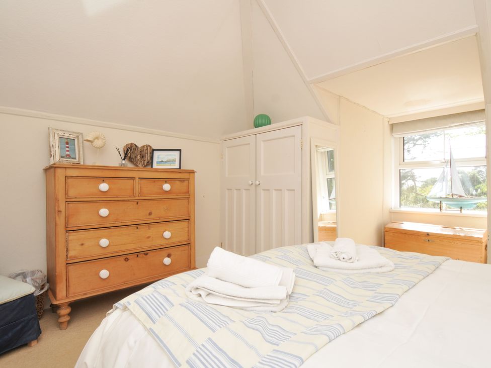 A bedroom with a bed and chest of drawers at Sandy Lodge Rock