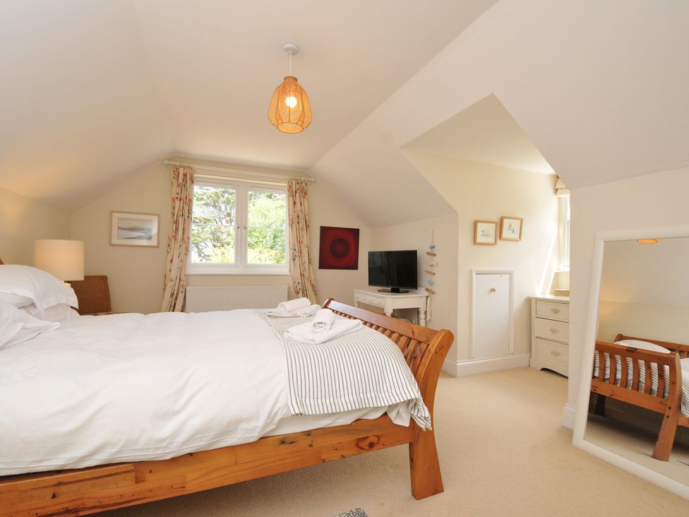 A bedroom with a bed and television at Sandy Lodge Rock