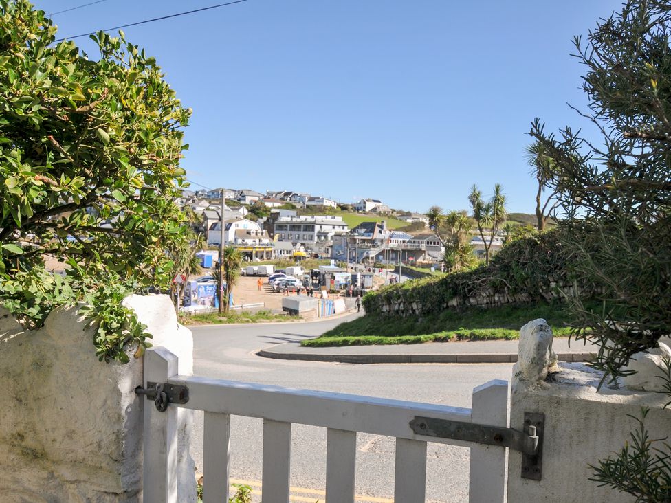 View of a street and beach area at Coppingers Cottage in Polzeath