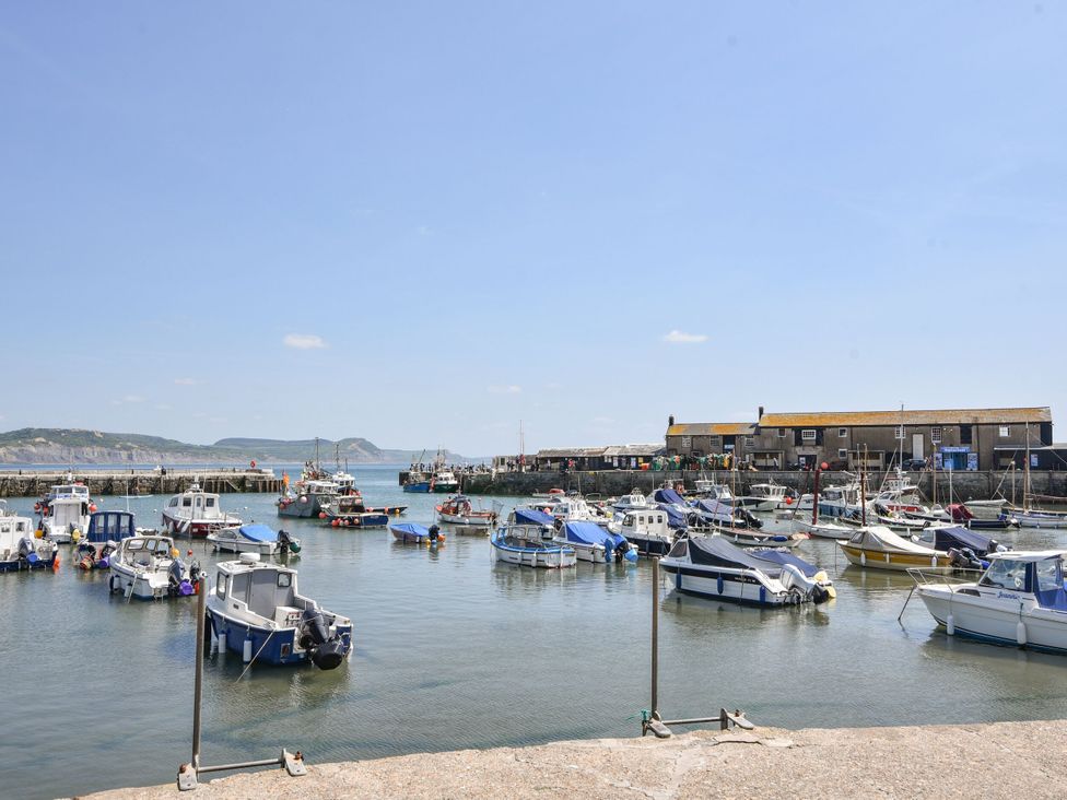 A harbor with boats and buildings at Coppingers Cottage in Polzeath