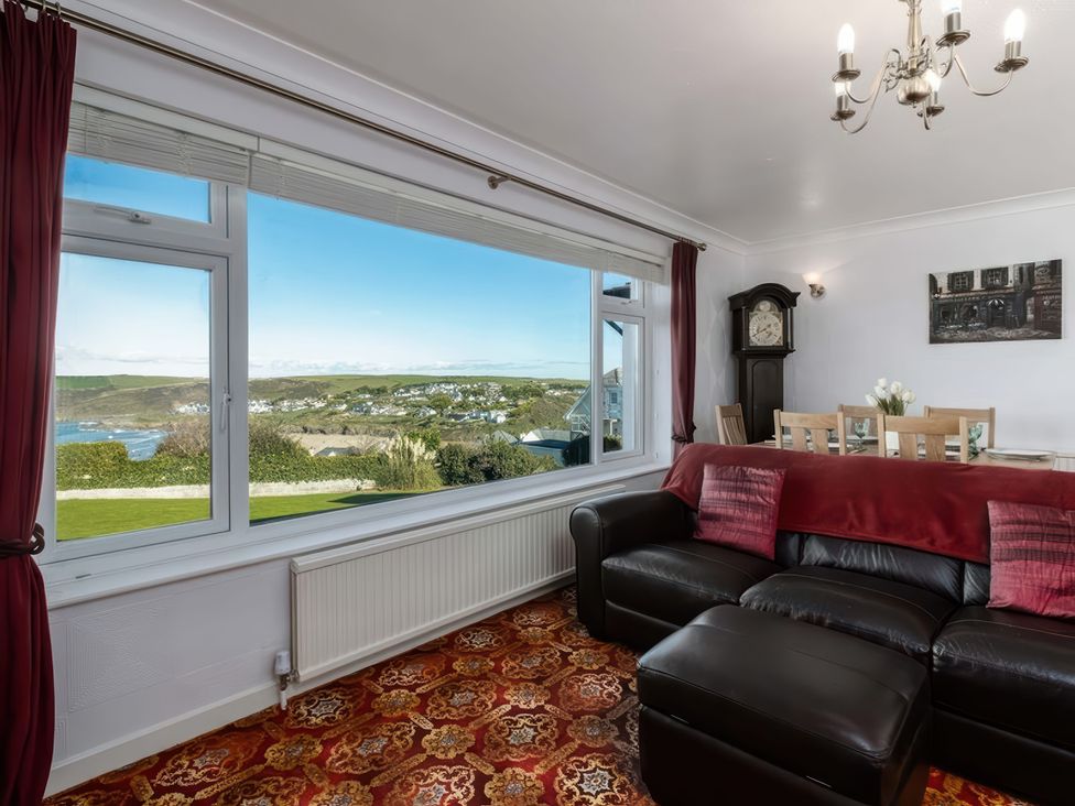 A living room with a view and furniture at Hillview in Polzeath