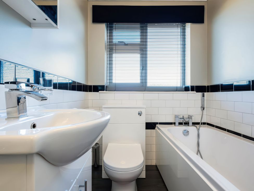 A bathroom with a sink, toilet, and bathtub at Hillview in Polzeath