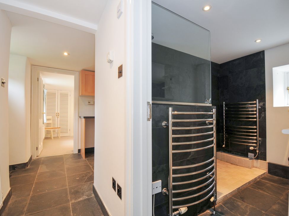 A bathroom featuring a shower and radiator at Orchard Cottage Polzeath