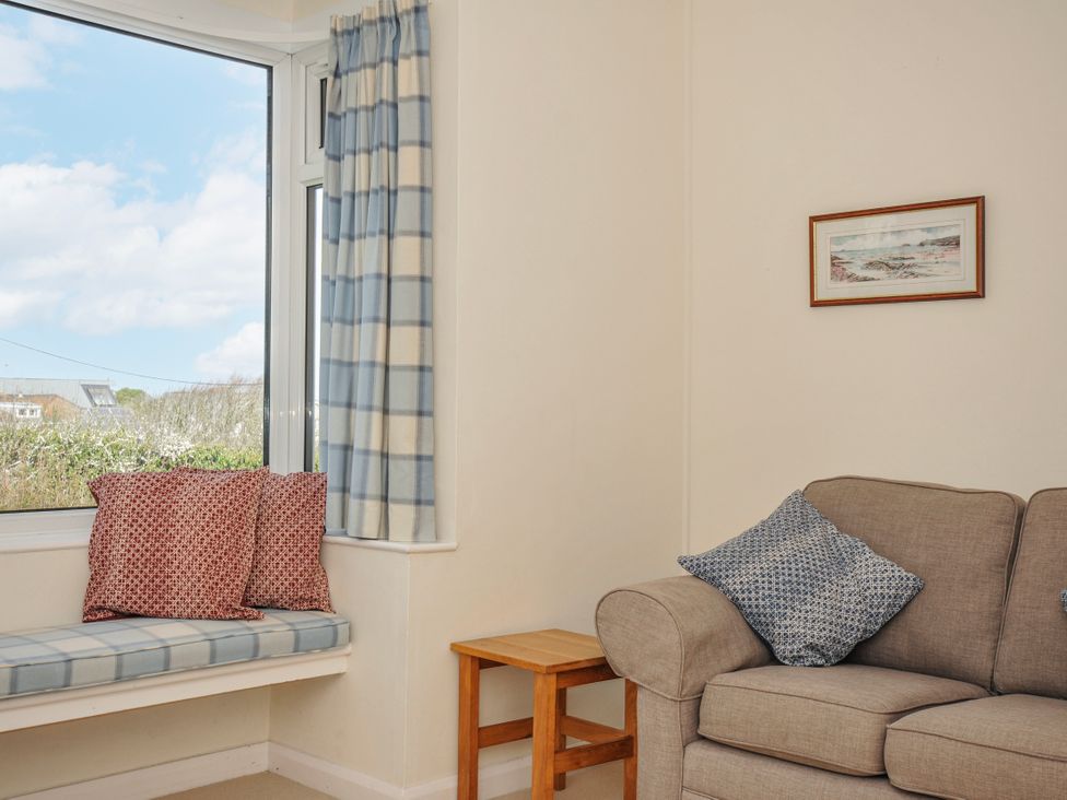 A living room featuring a window with curtains and seating at Hillcroft Bungalow Daymer Bay