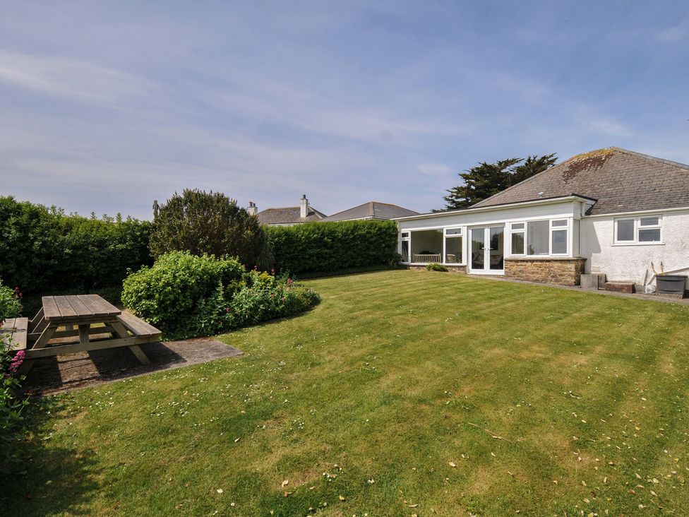 A garden with a picnic table and chairs at Hillcroft Bungalow Daymer Bay