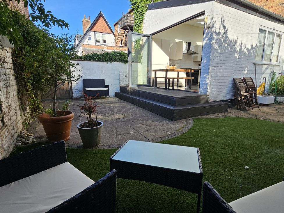 A garden with seating area and potted plants at South Bay House in Scarborough