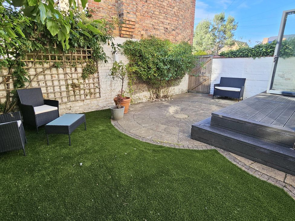 A garden with patio furniture and a plant pot at South Bay House in Scarborough