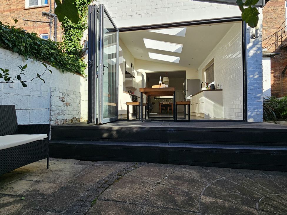 A kitchen with an open sliding door and outdoor steps at South Bay House in Scarborough