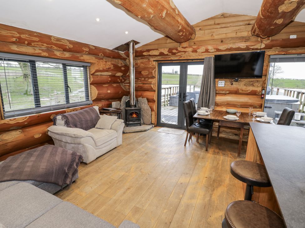 A living room with a sofa and dining table at Douglas Cabin at Salford Court Farm Fishing Cabins near Clifton Upon Teme