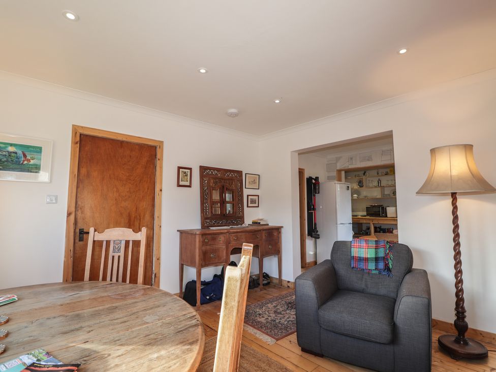A living room with a table and sofa at Free Presbyterian Manse in Kinlochbervie