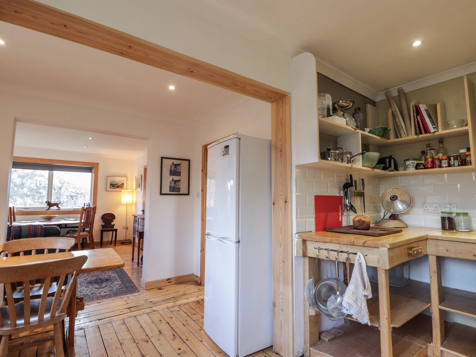 A kitchen with a refrigerator and table at Free Presbyterian Manse in Kinlochbervie
