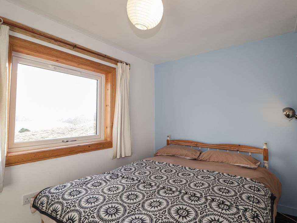 A bedroom with a bed and window at Free Presbyterian Manse in Kinlochbervie