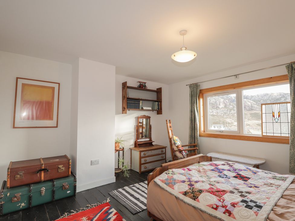 A bedroom with a bed and desk at Free Presbyterian Manse in Kinlochbervie