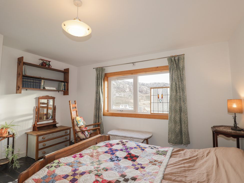 A bedroom with a bed and a window at Free Presbyterian Manse in Kinlochbervie