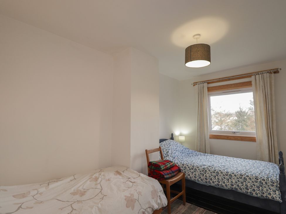 A bedroom with two beds and a window at Free Presbyterian Manse in Kinlochbervie