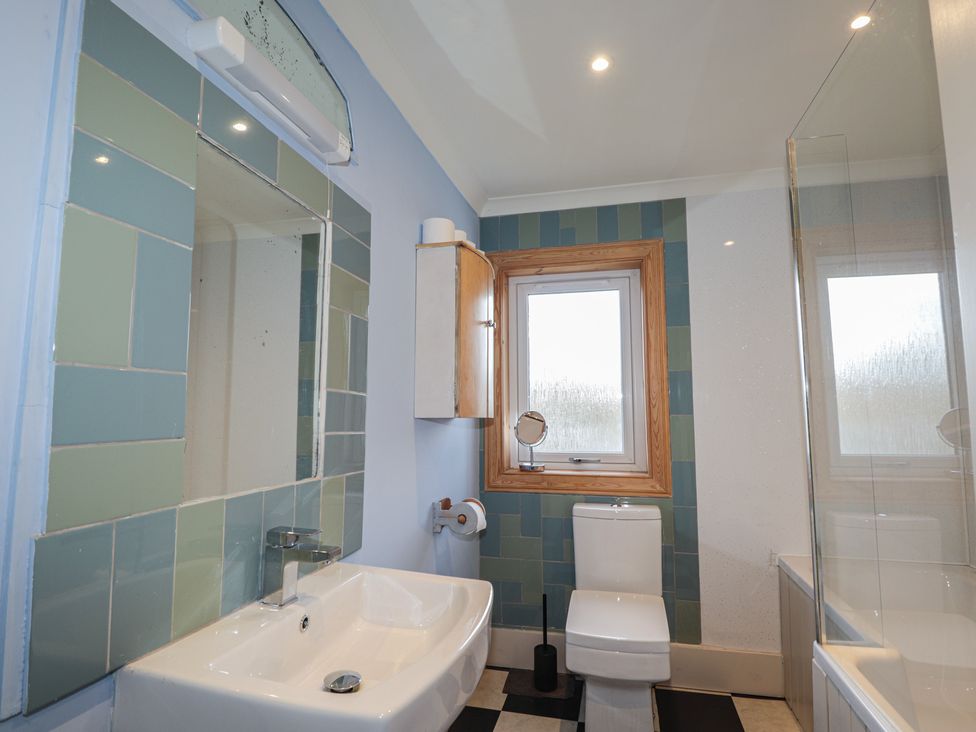 A bathroom with a sink, toilet, and shower at Free Presbyterian Manse in Kinlochbervie