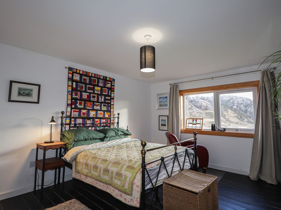 A bedroom with a bed and window at Free Presbyterian Manse in Kinlochbervie